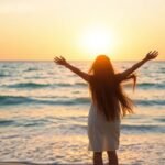 Woman on beach, sunrise, freedom.