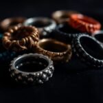 Variety of textured cock rings on a dark surface.